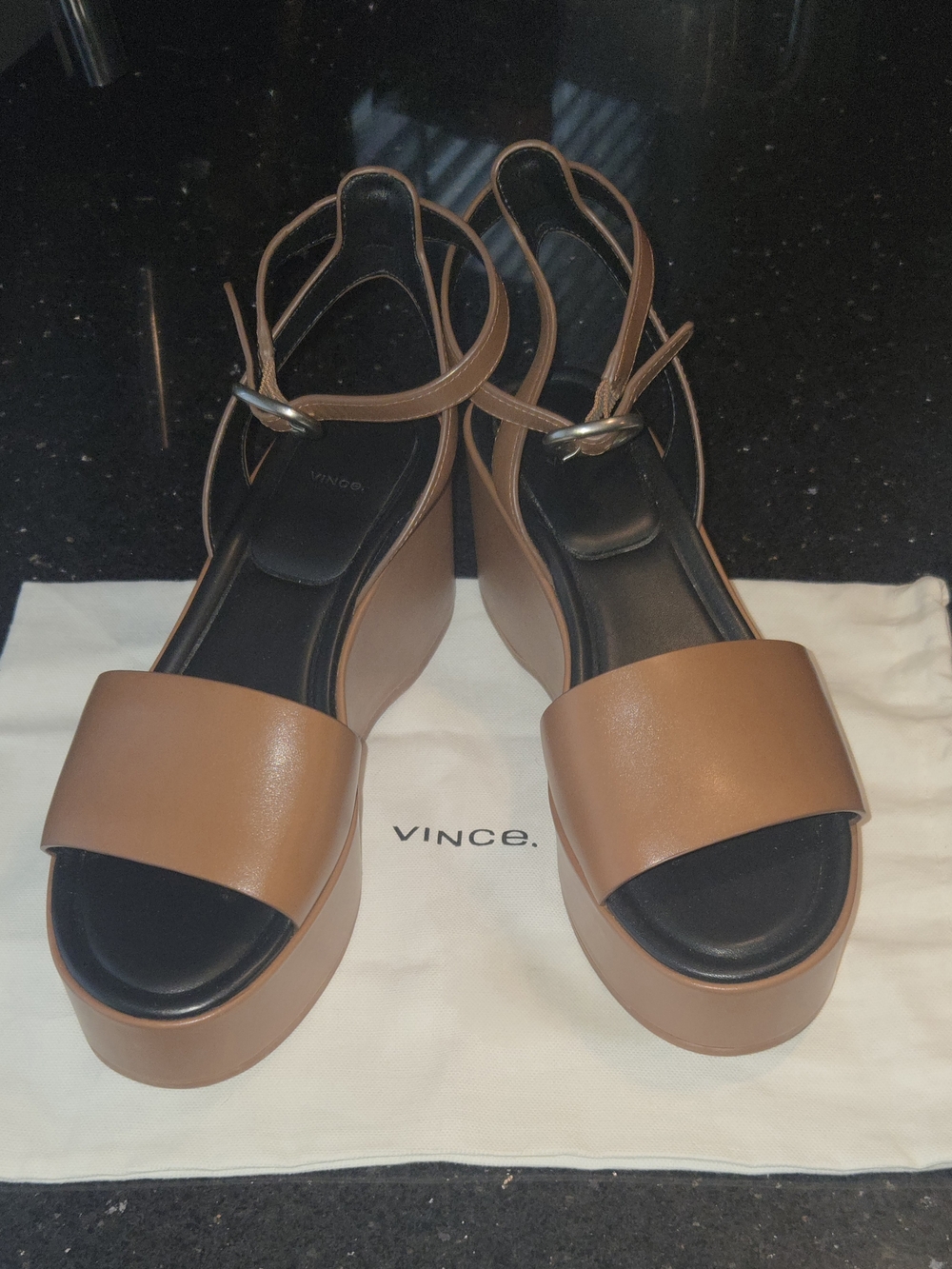 Vince Women's Phillipa Platform Ankle Strap Sandals resting on a dust bag.